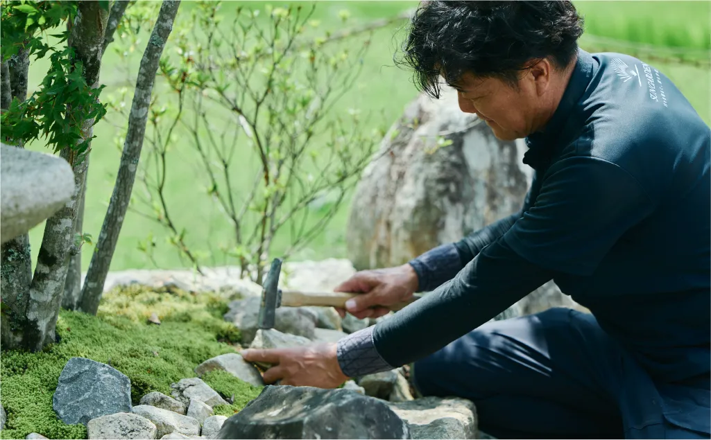 庭で男性が作業をする様子